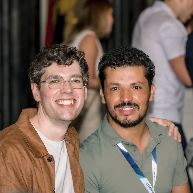 Two teammates side by side at a company reception