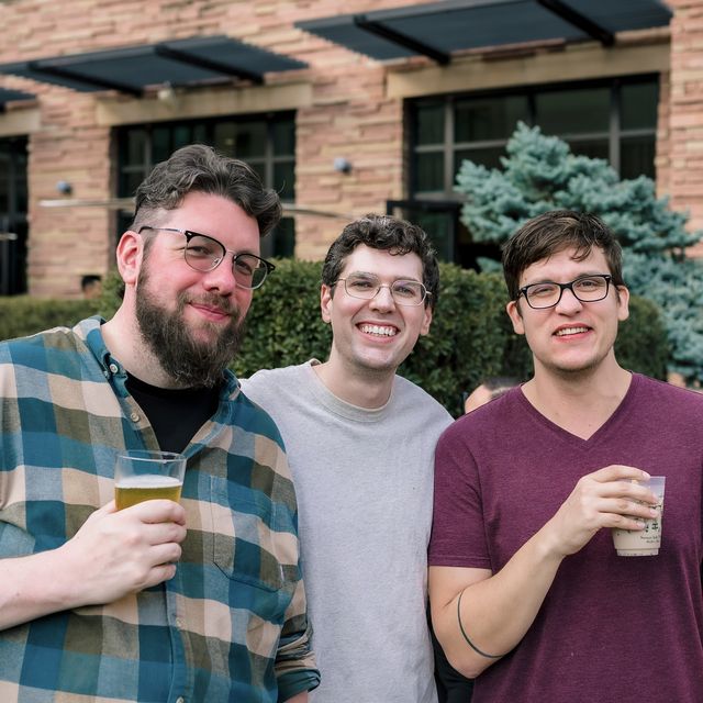 Three teammates catching up over drinks at an offsite