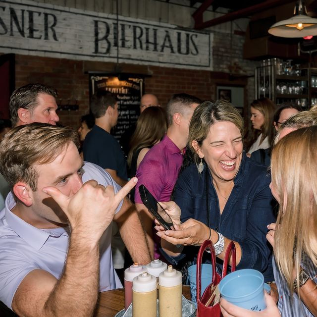 Teammates laughing together at a bierhaus