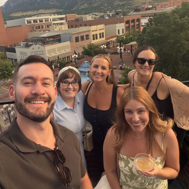 Teammates on the rooftop deck in the evening