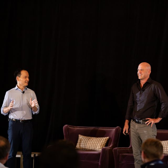 Two teammates on stage during a fireside session