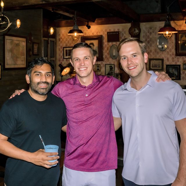 Three teammates at an evening team dinner