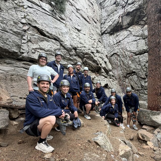 The team gathered below a rock face on a climbing outing