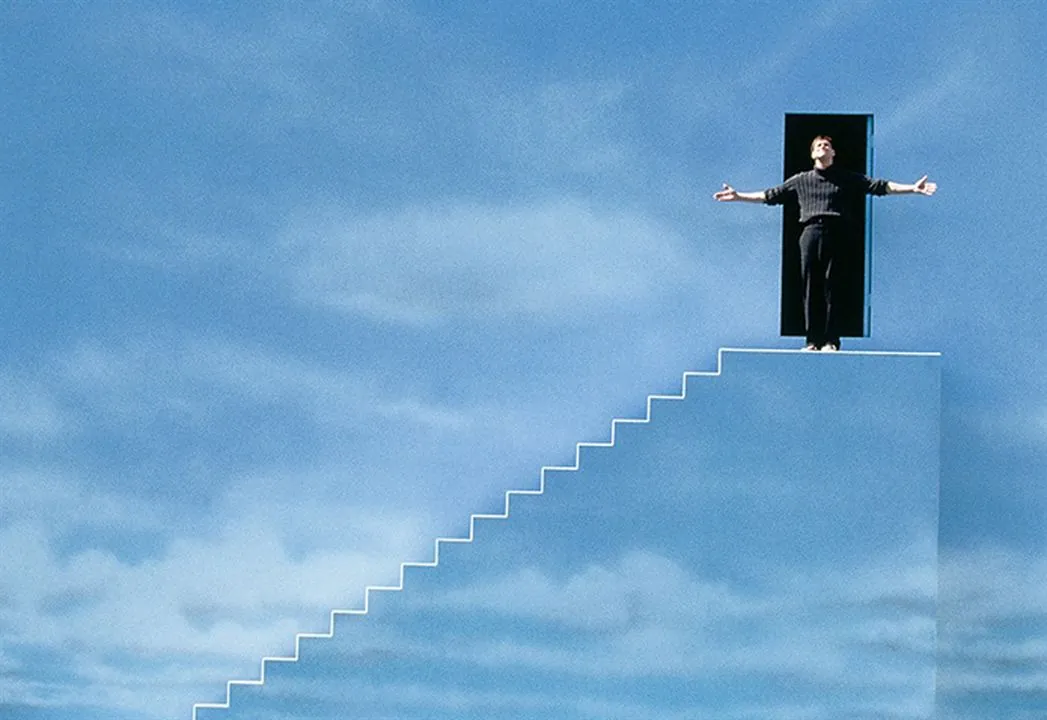 Personne au sommet d'un escalier qui mène vers une porte dans le ciel