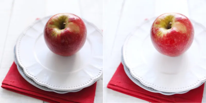 Deux pommes identiques sur des assiettes blanches