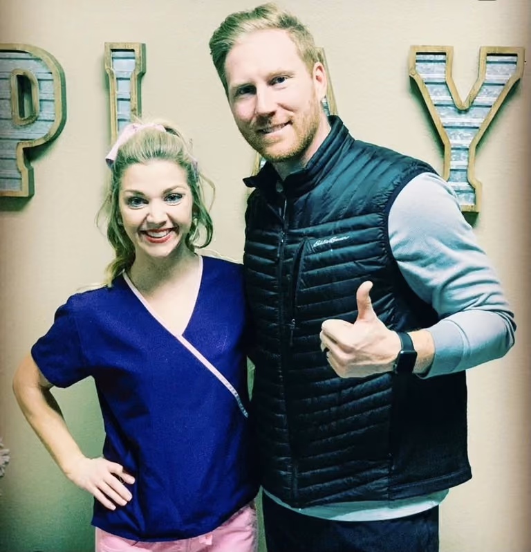 Dr. Emily Heisey and Dr. Matt Otteman in front of a PLAY sign at the clinic