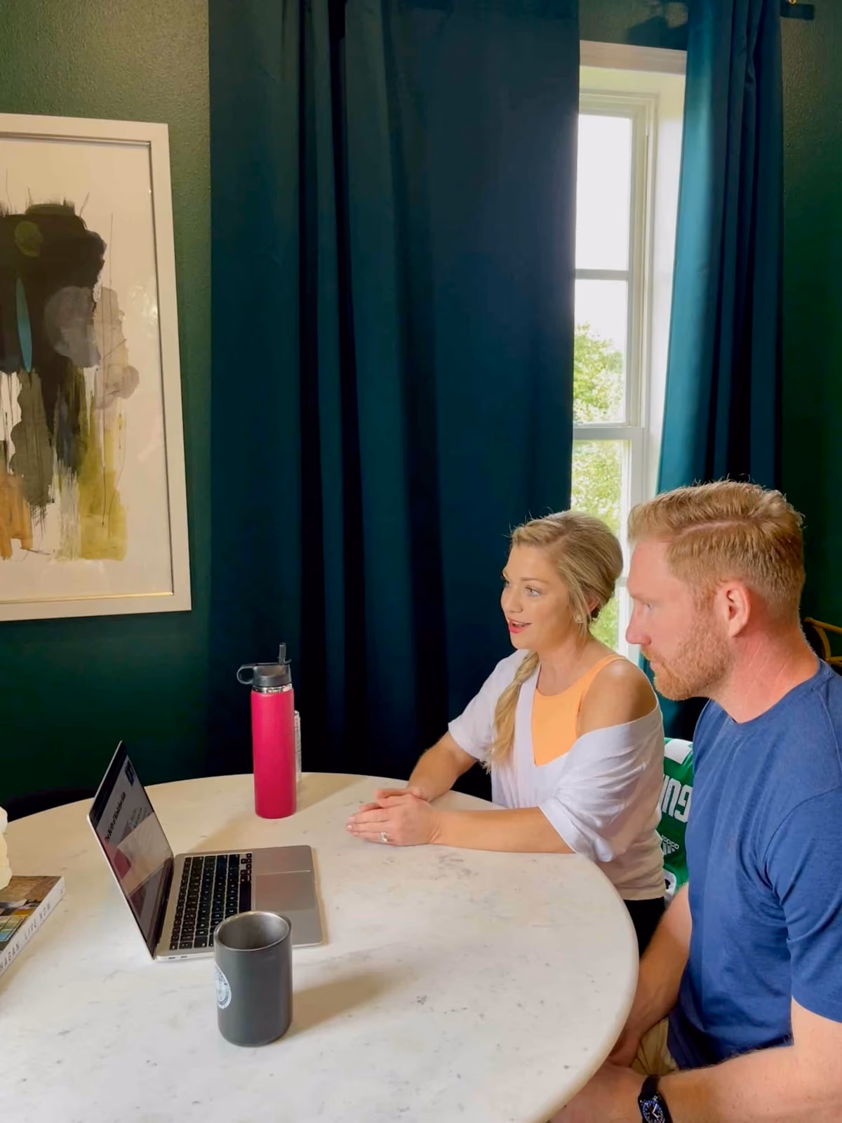 Dr. Emily Heisey and Dr. Matt Otteman recording a KinActive University lesson at a laptop