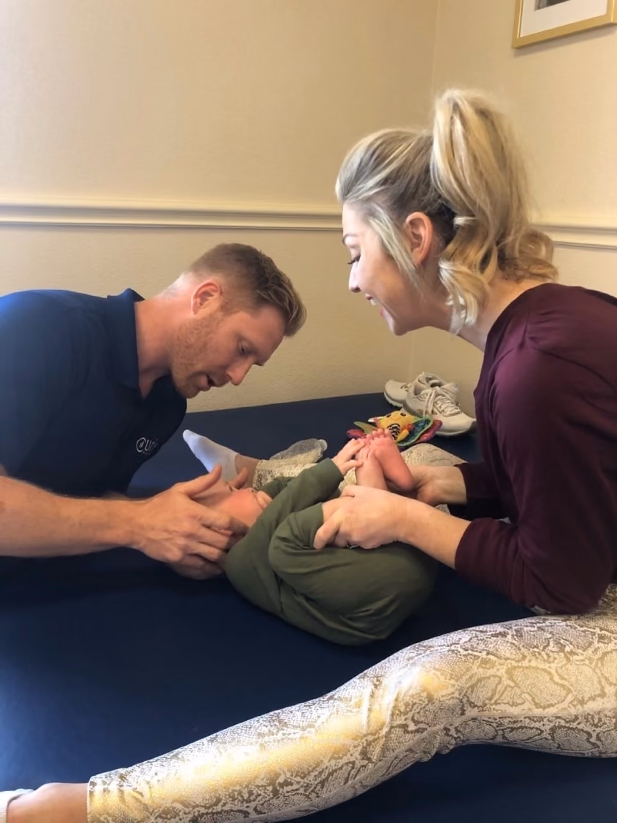 Dr. Matt Otteman and Dr. Emily Heisey co-treating an infant on a navy therapy mat