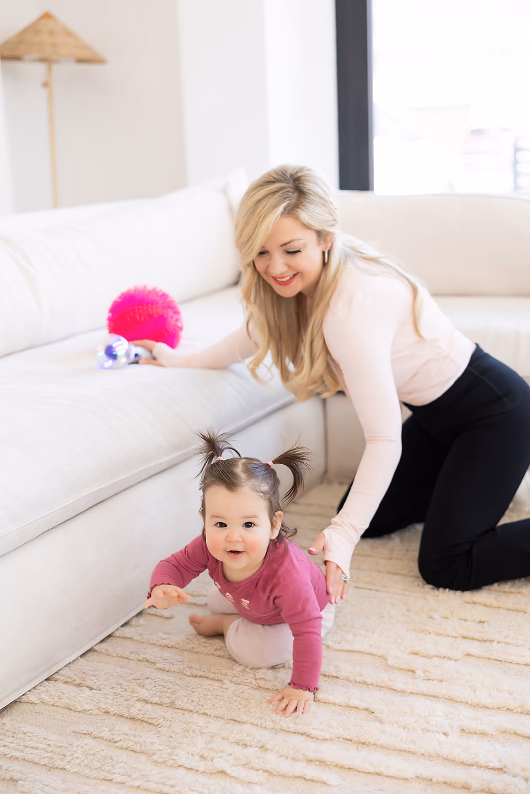 A pediatric physical therapist evaluating a young child with her mother