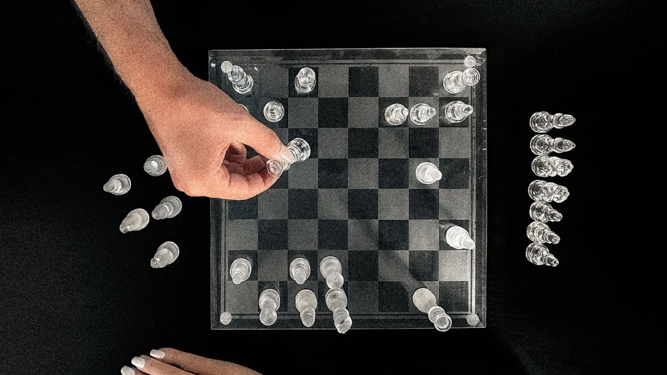 A glass chess board mid-game, seen from above