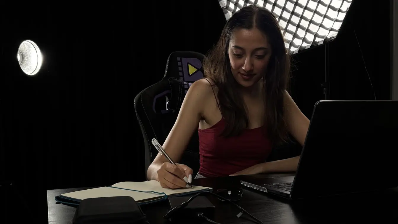 Handwritten project-scope notes beside a laptop