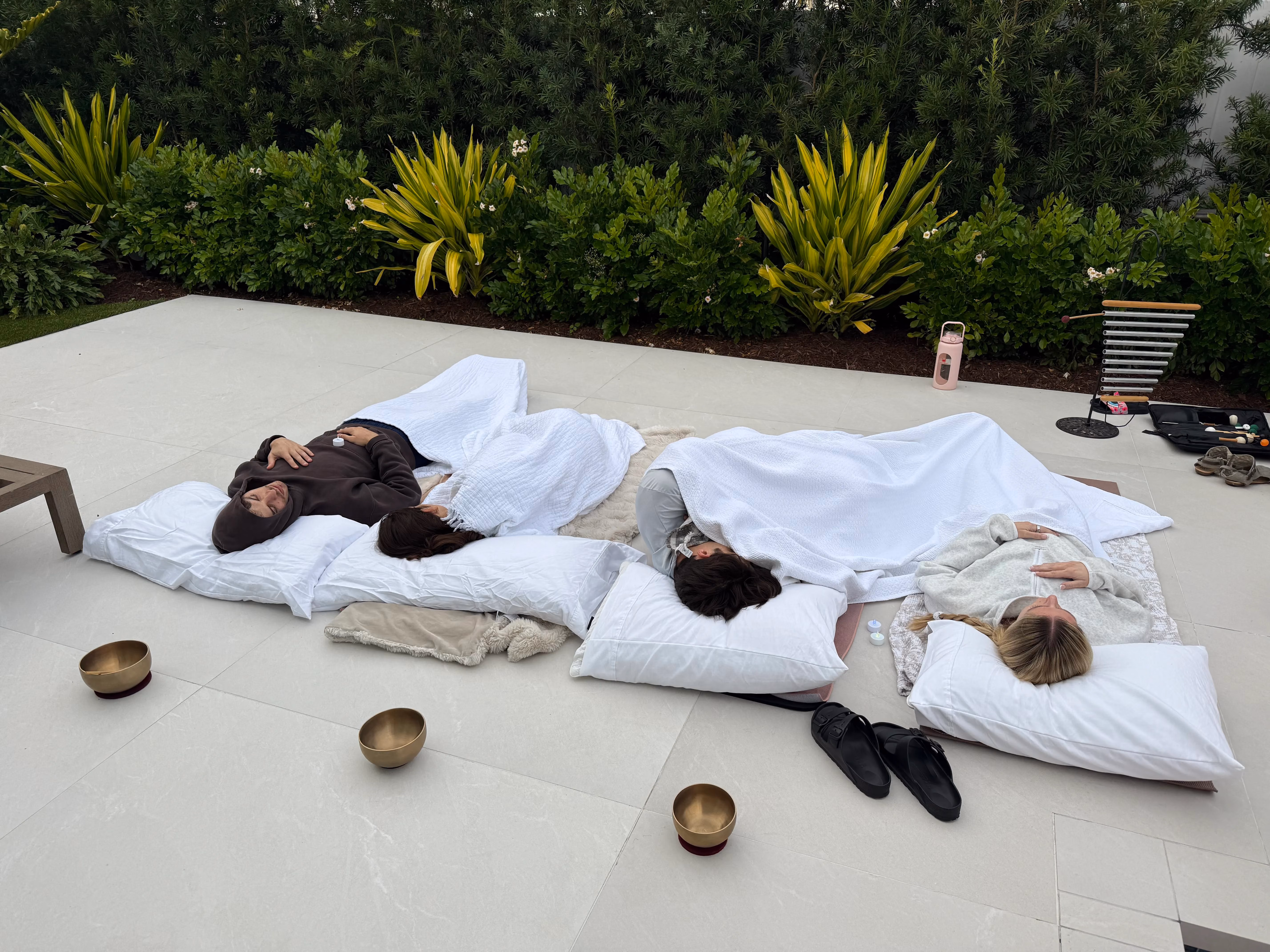 Participants resting on mats during a sound bath