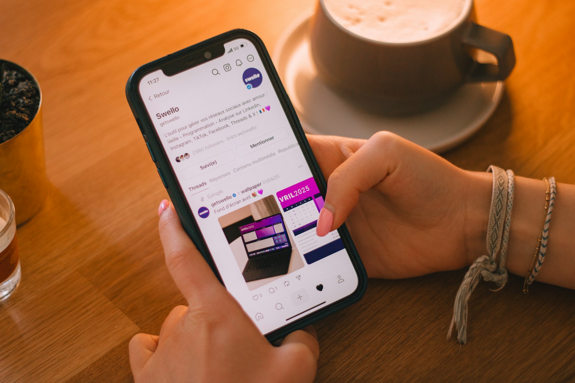 Close view of a person scrolling on a smartphone in purple light