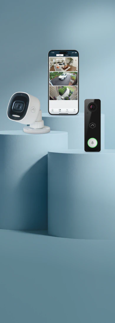 Brinks Home outdoor camera, smartphone app showing live camera feeds, and video doorbell displayed on studio pedestals