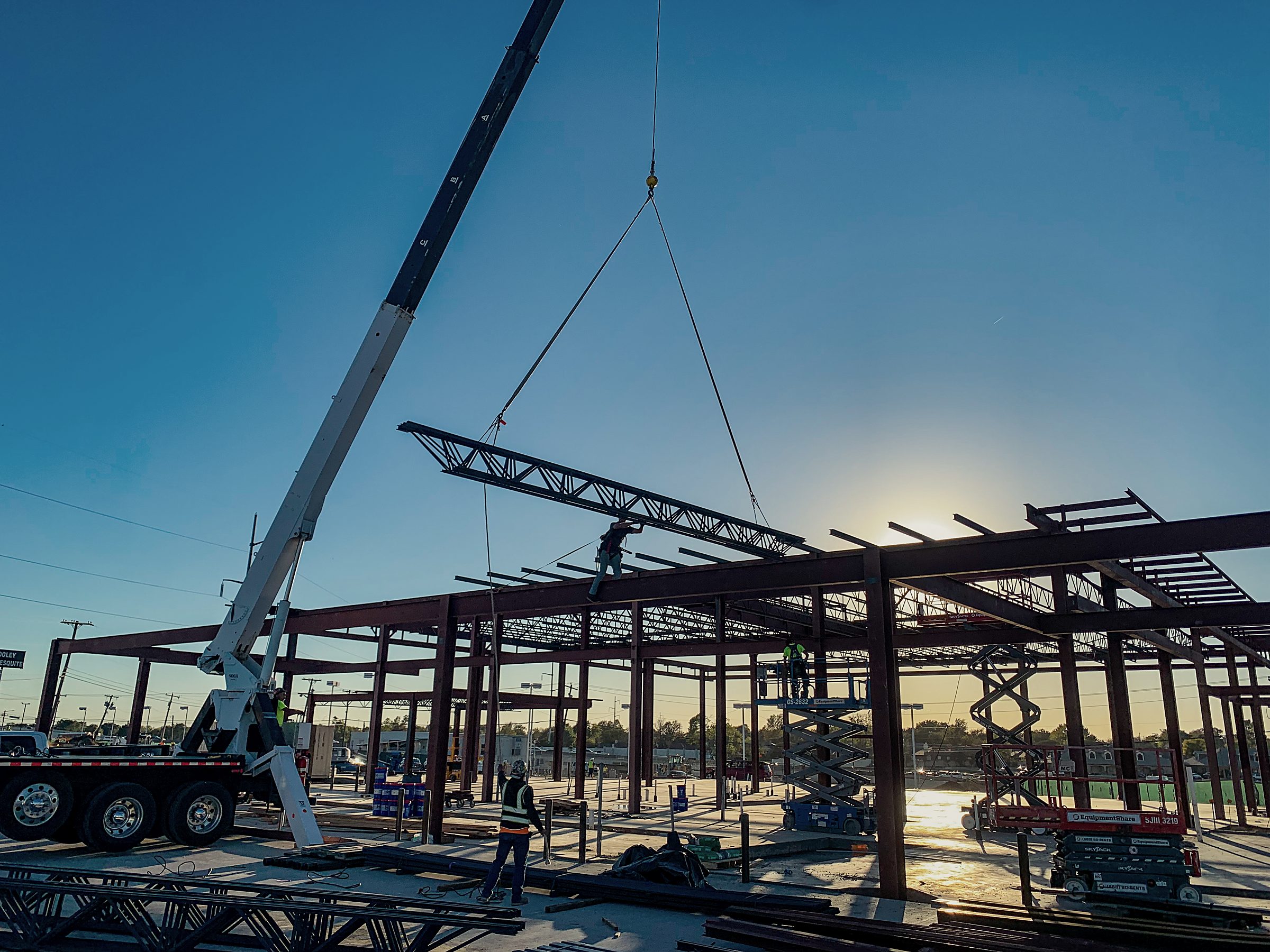 Silhouette of a completed structural steel frame at dusk