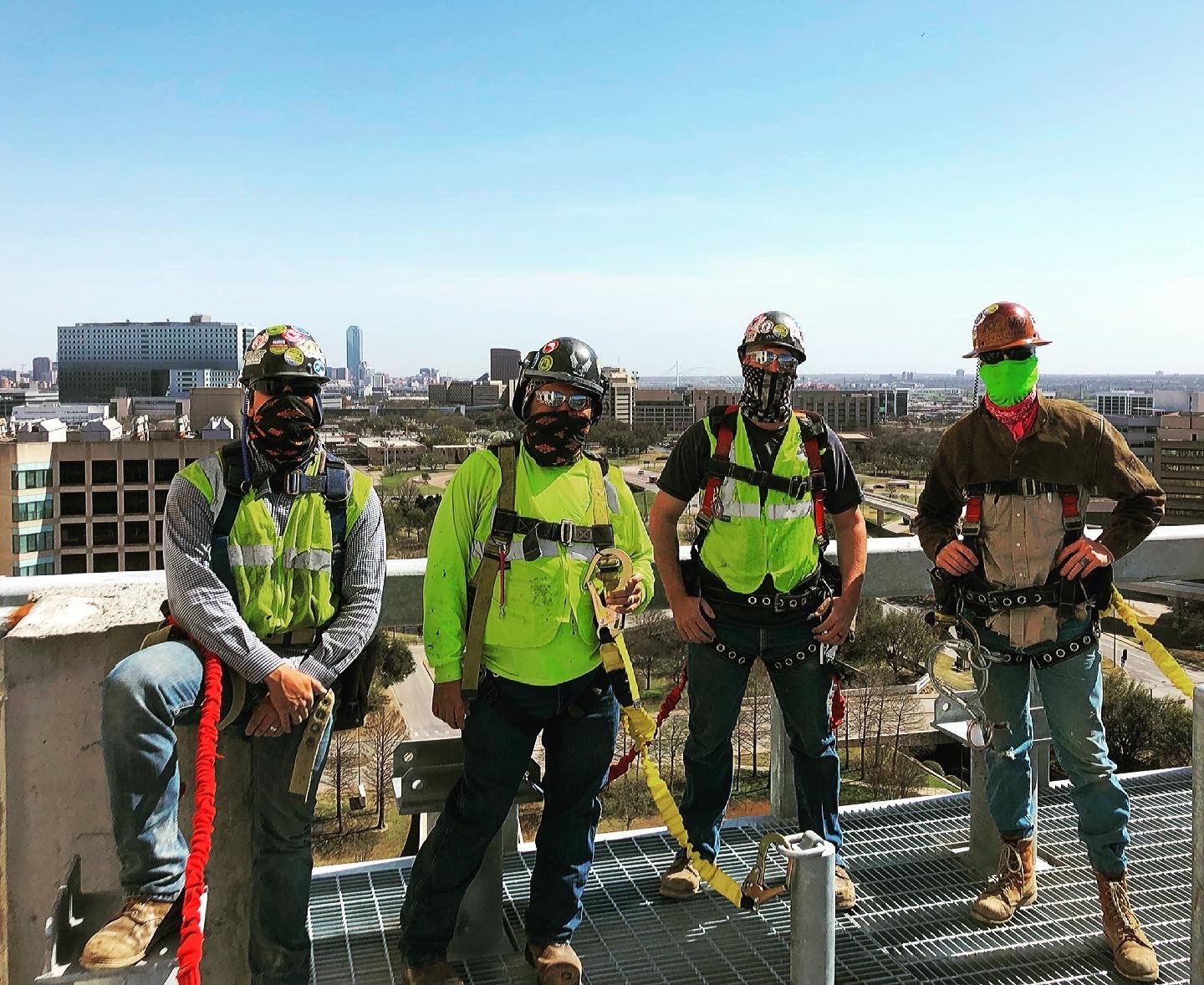 Hot Shot crew in full-body harnesses and hard hats on an elevated steel deck