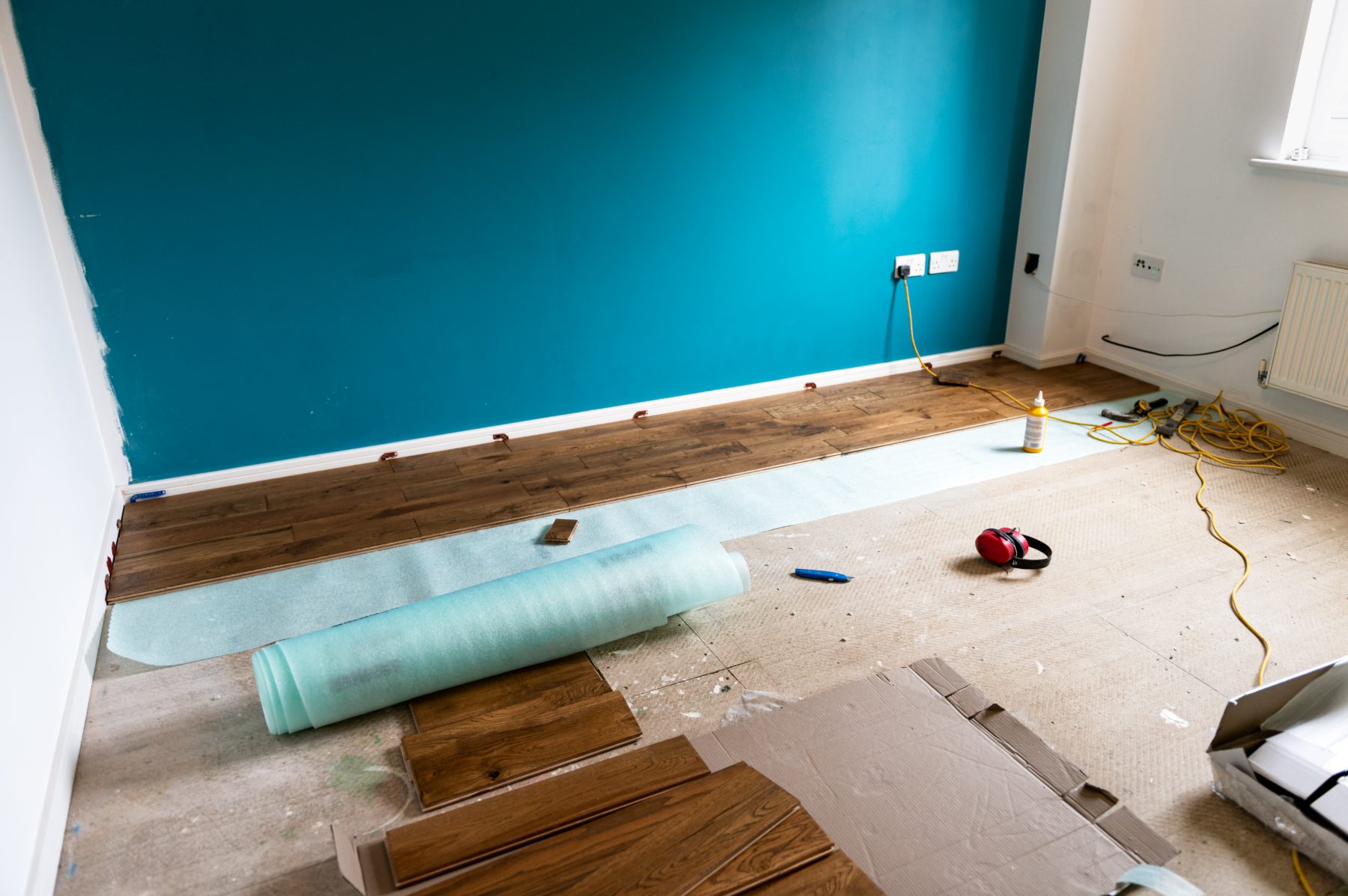 New flooring being installed in a finished room