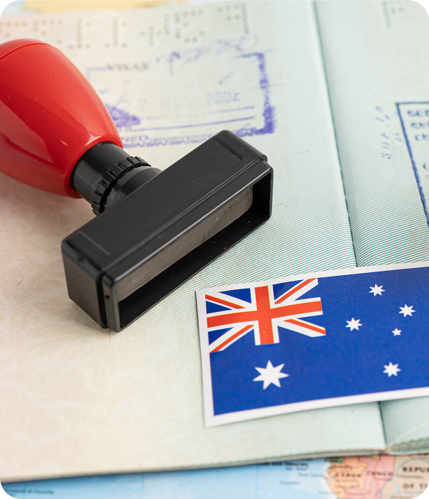 Rubber stamp and Australian flag beside a passport, common partner visa refusal grounds