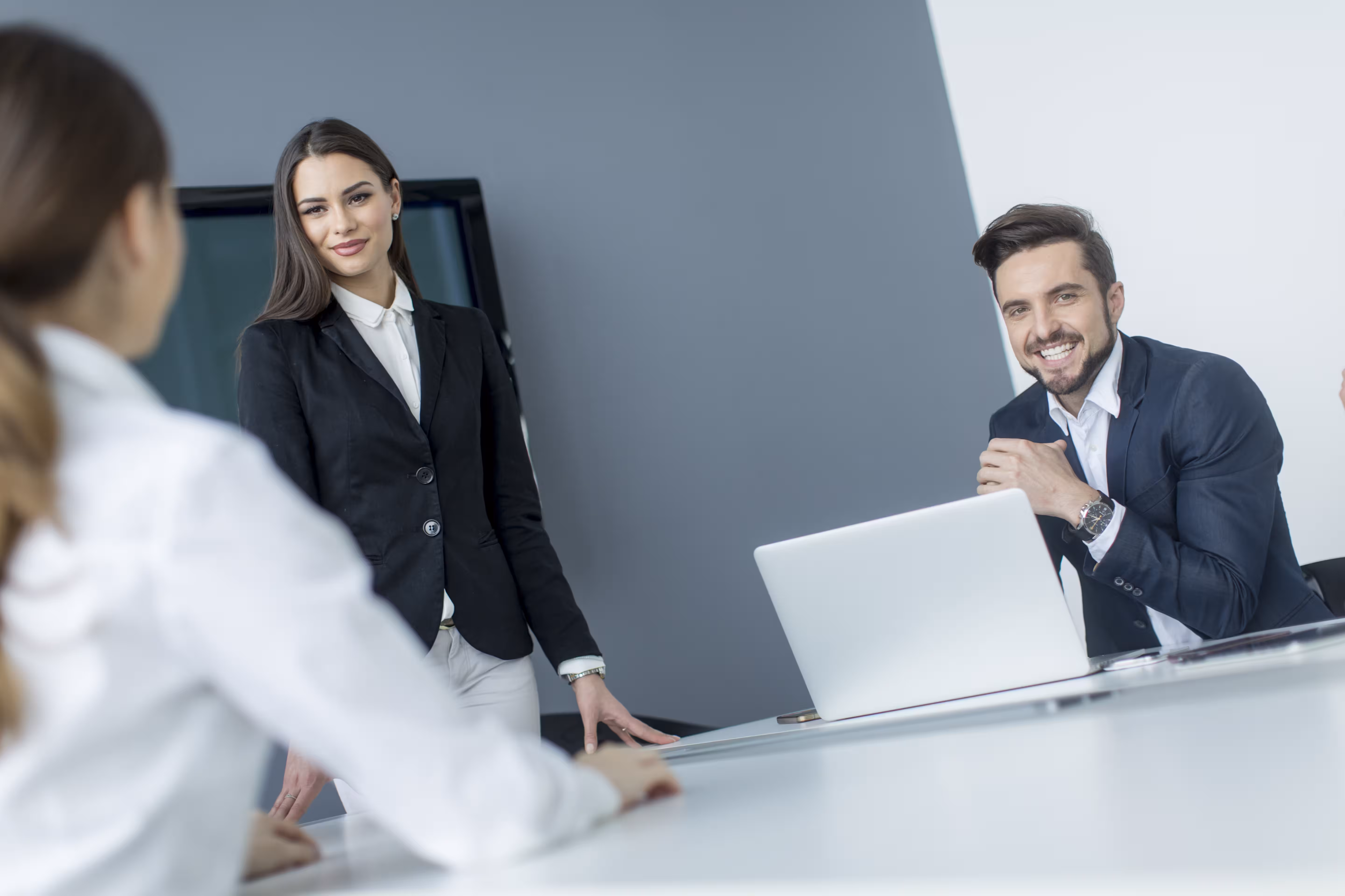 Colleagues smiling during a meeting in a bright office