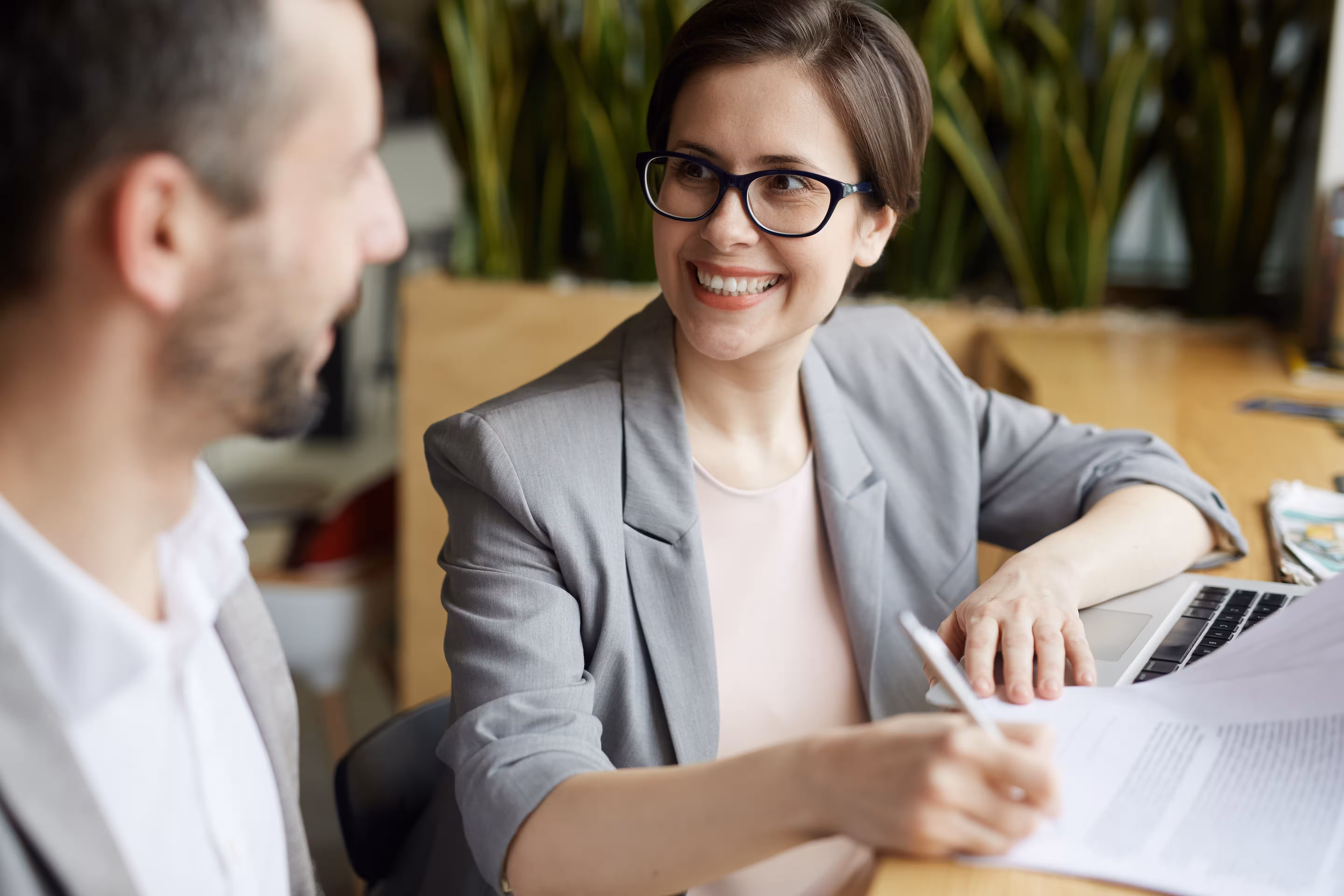 Smiling lawyer reviewing documents with a client