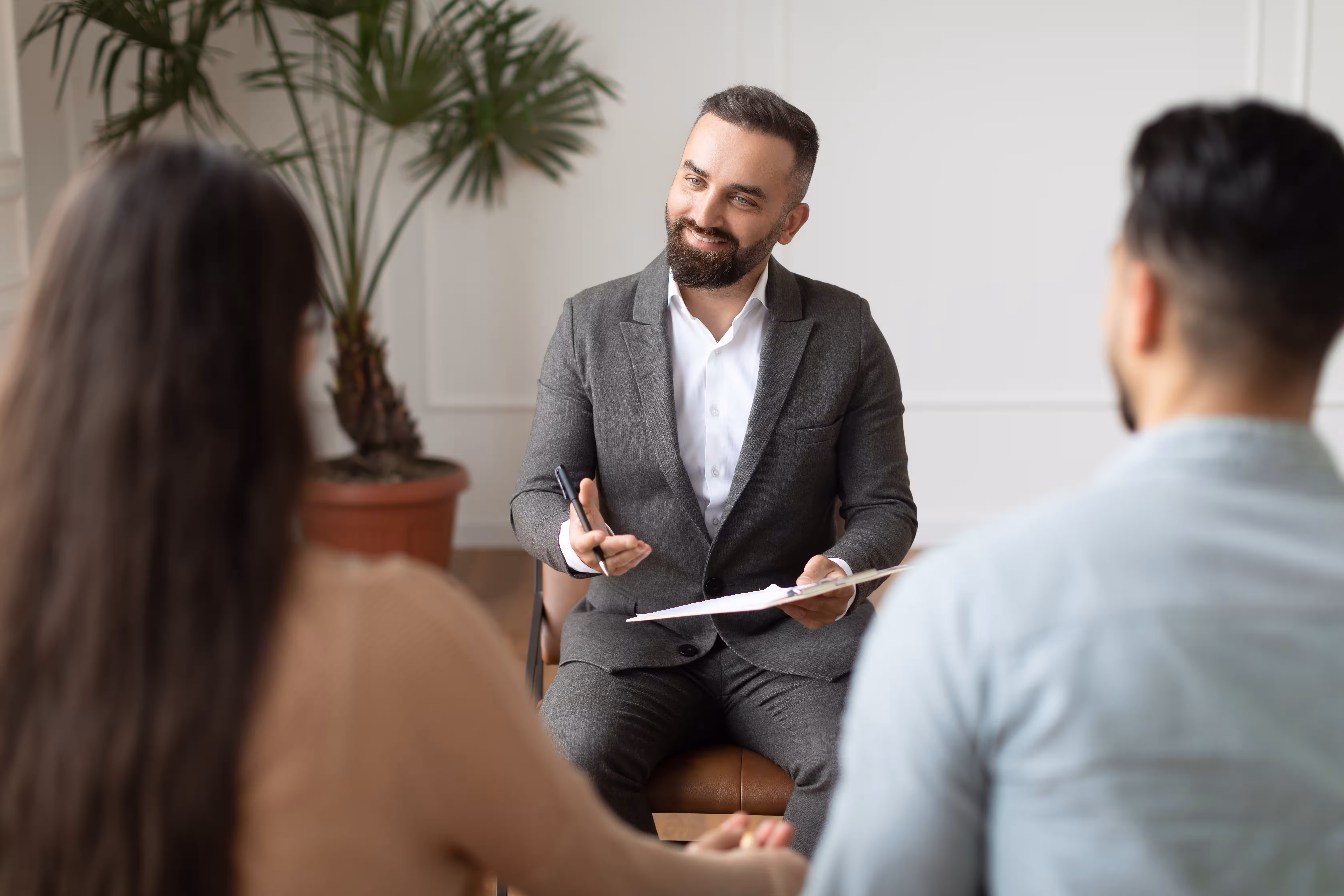 Lawyer meeting a couple to discuss their Partner visa