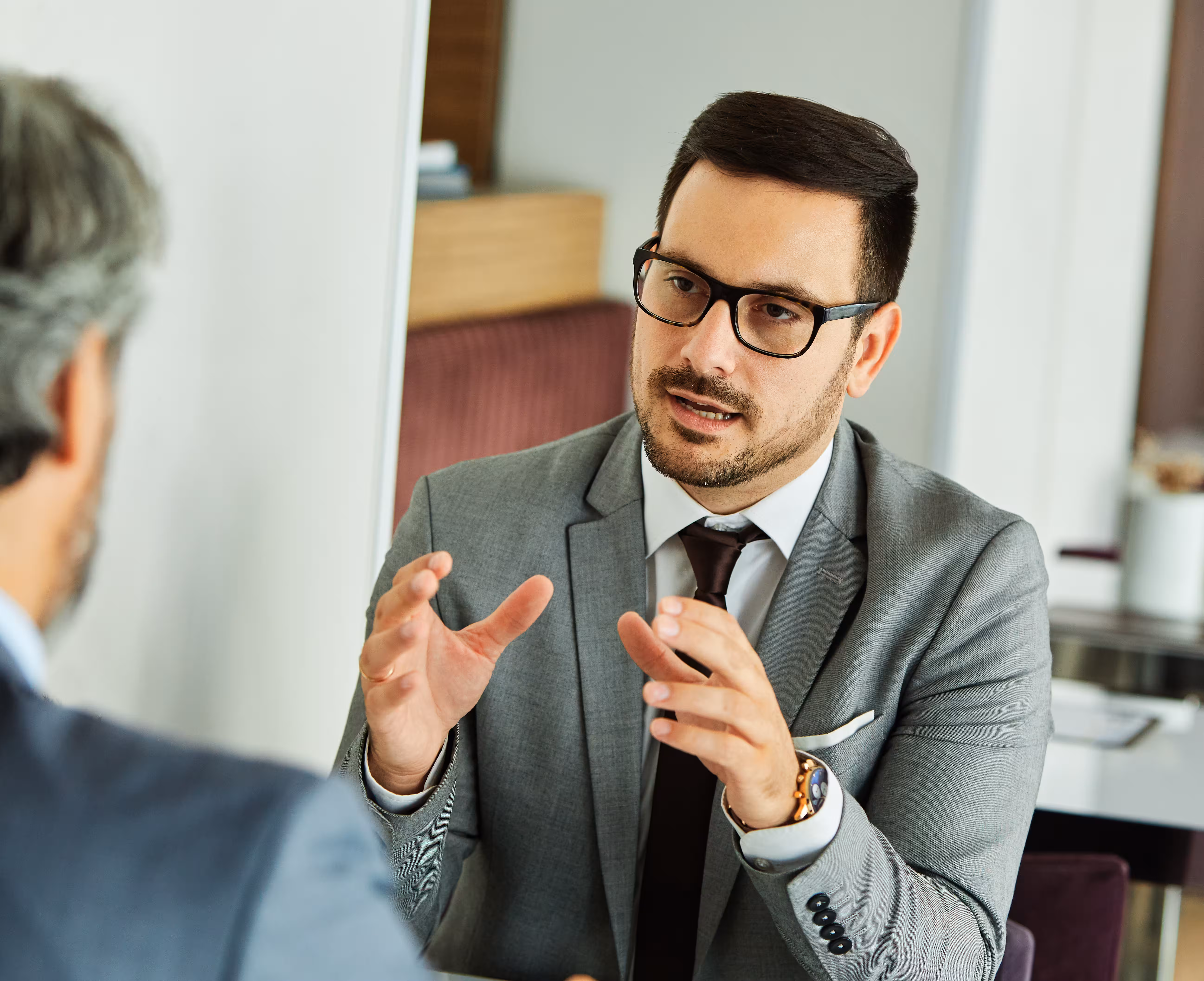 Lawyer in glasses explaining advice to a client