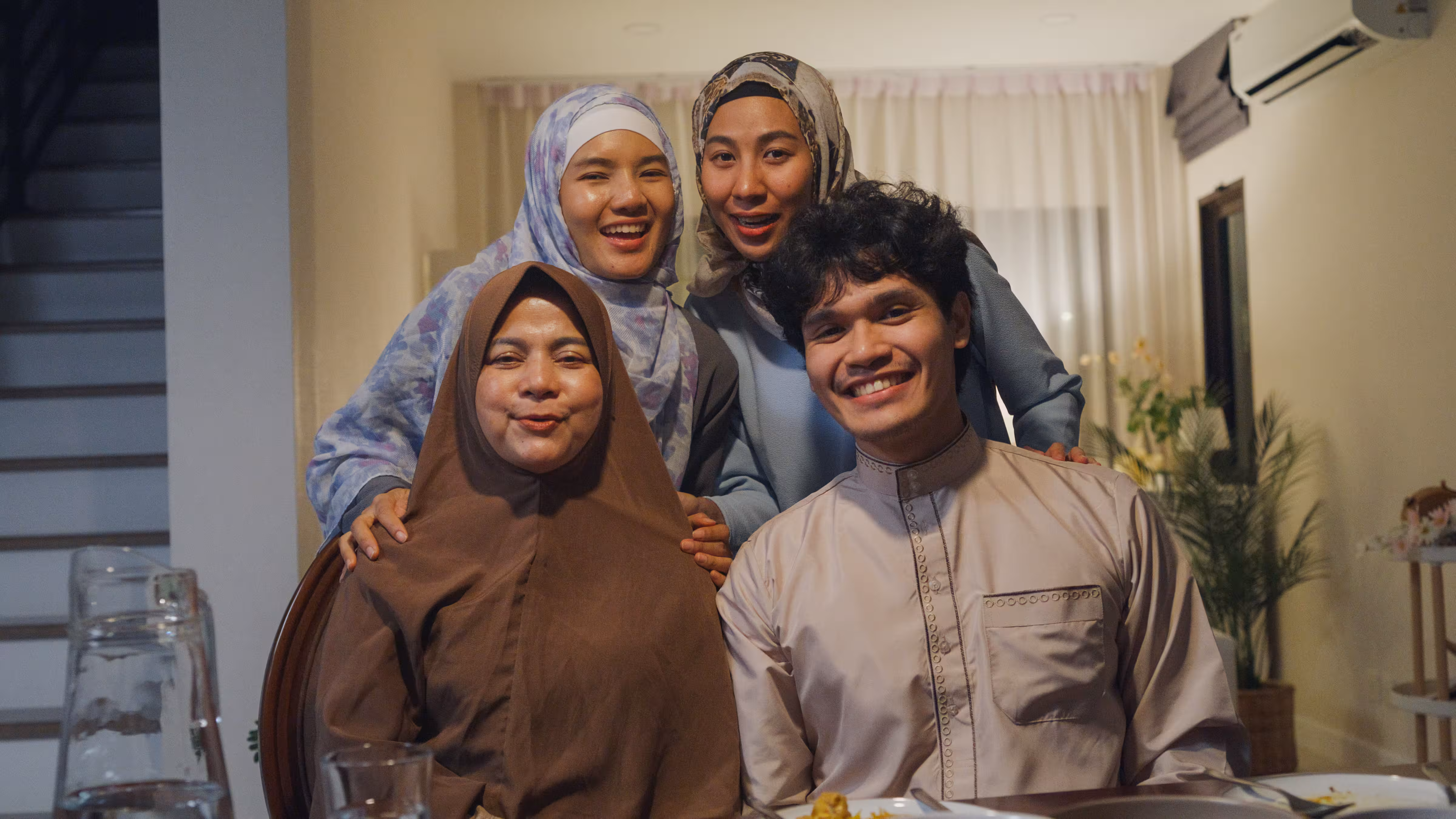 Family smiling together at home, Subclass 866 protection visa for Indonesians