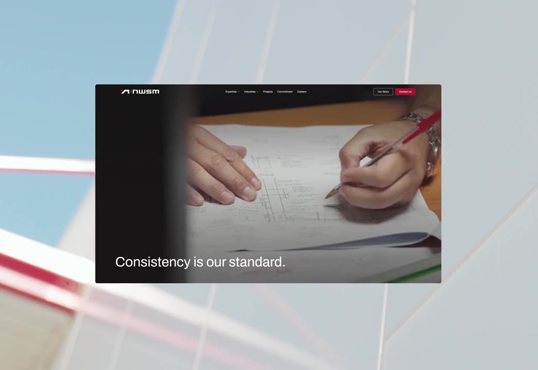 Hands sketching technical drawings on paper with a red pen on a desk.