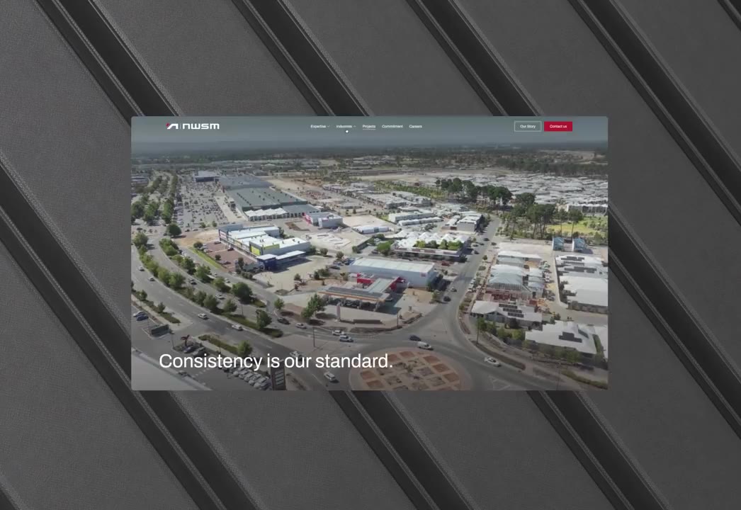Aerial view of urban area with roads and buildings, text overlay says 'Consistency is our standard.'