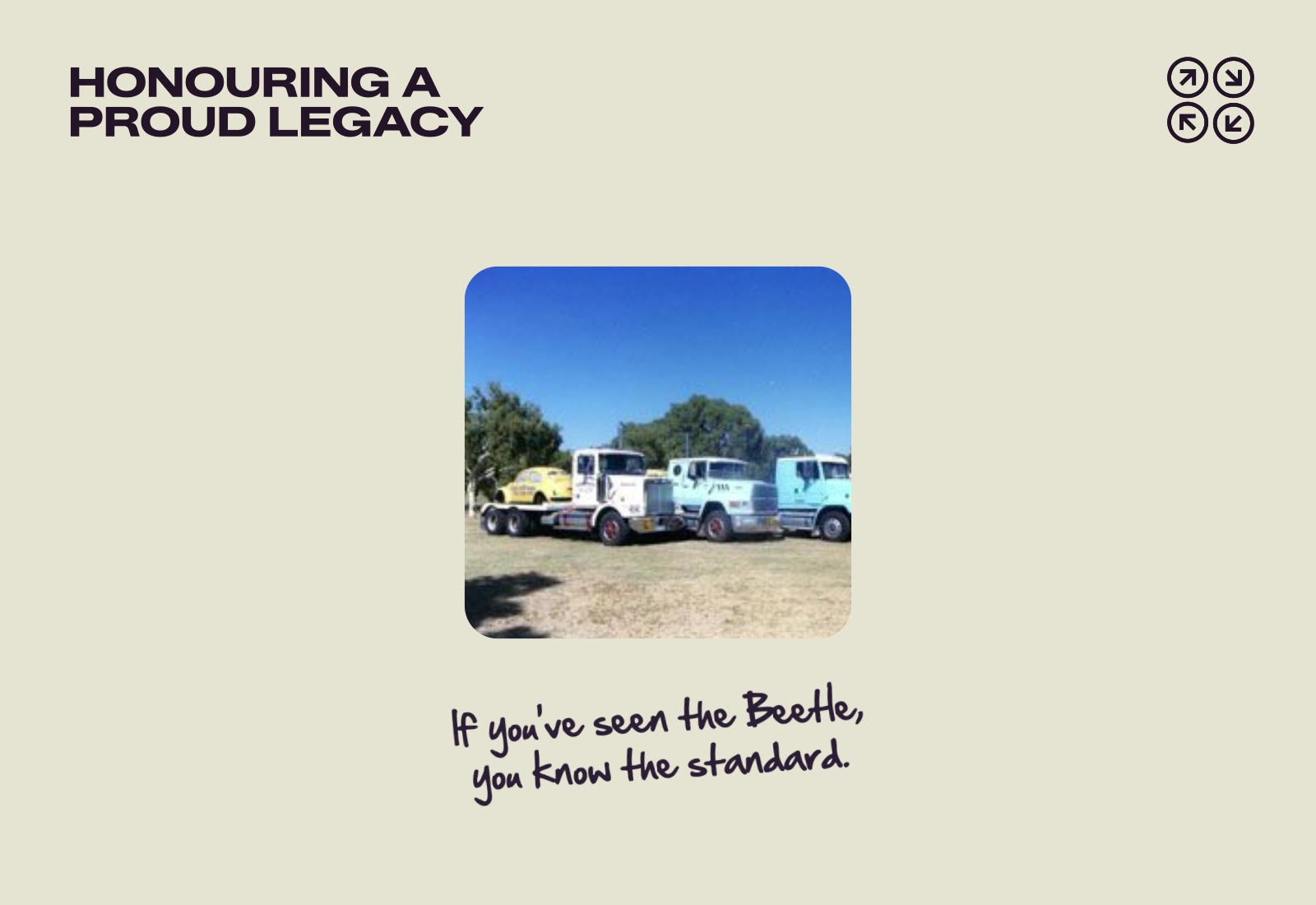 Three vintage trucks parked on grass with a yellow Beetle in the back of one, under a clear blue sky.