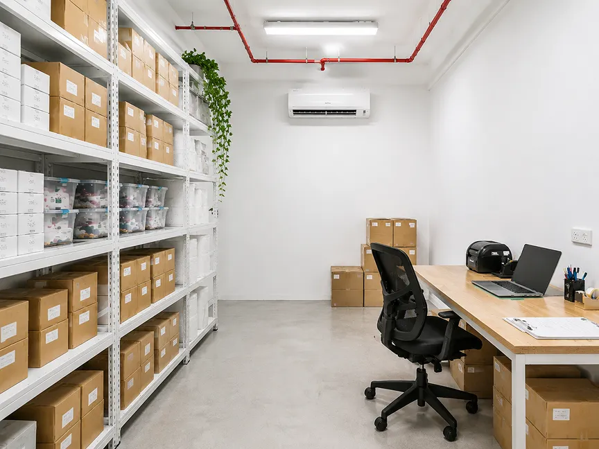 Workspace with storage unit with shelving, desk and air conditioning