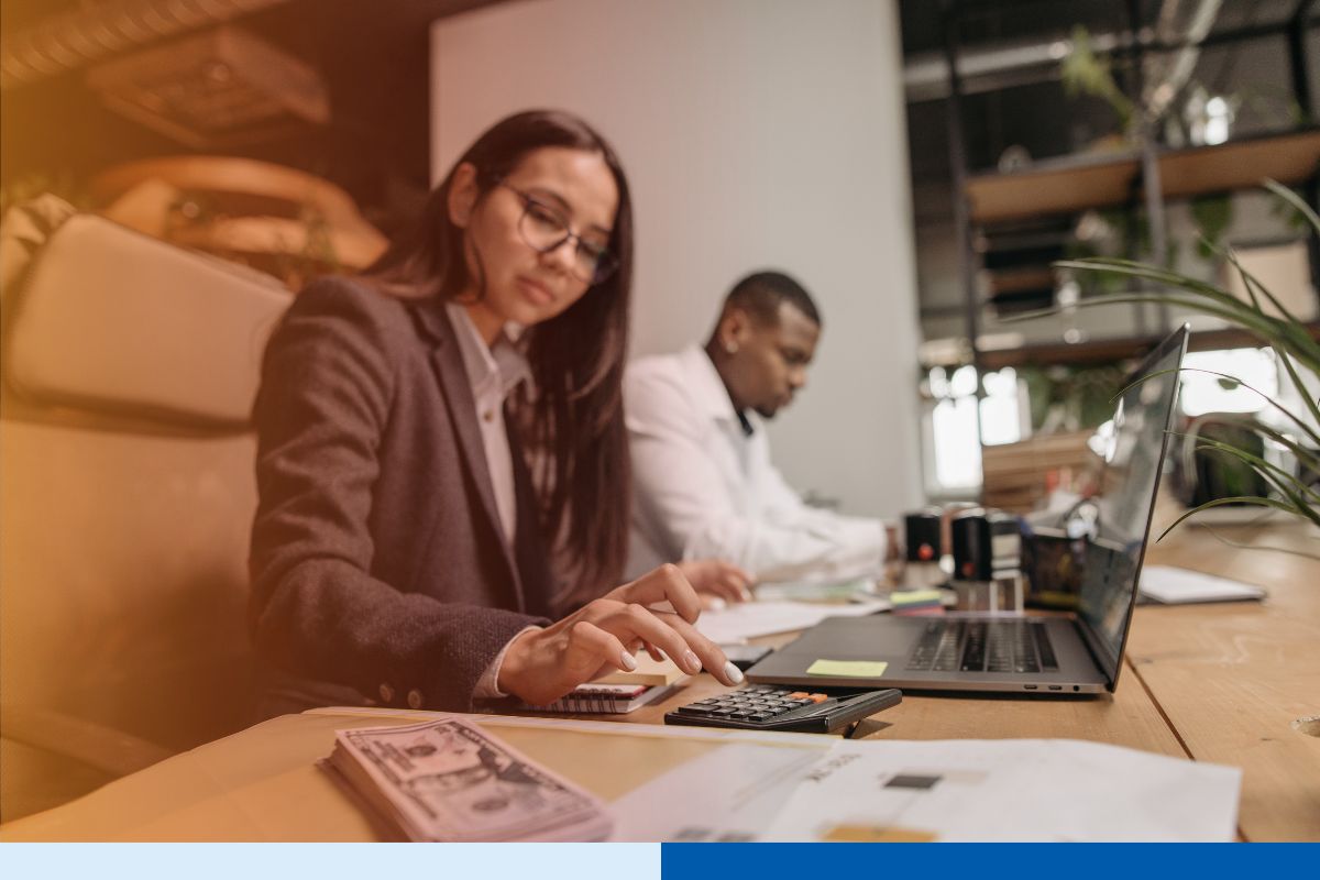 Offshore accounting professional processing accounts payable invoices on a laptop in a finance office
