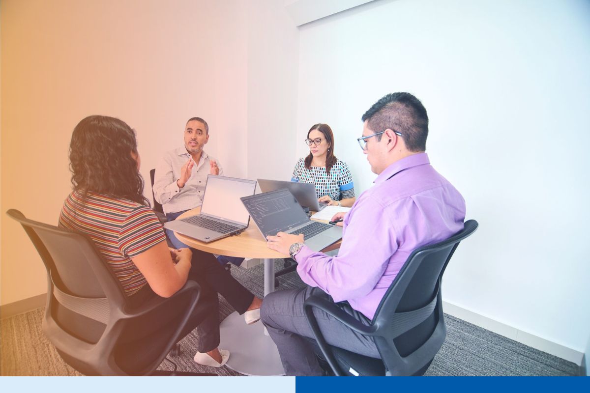 Offshore engineering team collaborating during a knowledge transfer session in a modern Latin America office