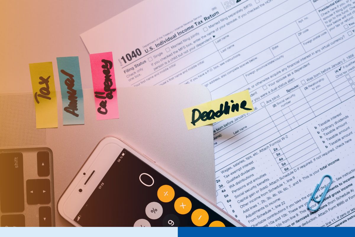 A IRS Form 1040 U.S. Individual Income Tax Return document on a desk next to sticky notes reading "Tax," "Annual," "Connext," and "Deadline," alongside a smartphone displaying a calculator app, illustrating Connext Global Solutions outsourced tax season offshore accounting staffing
