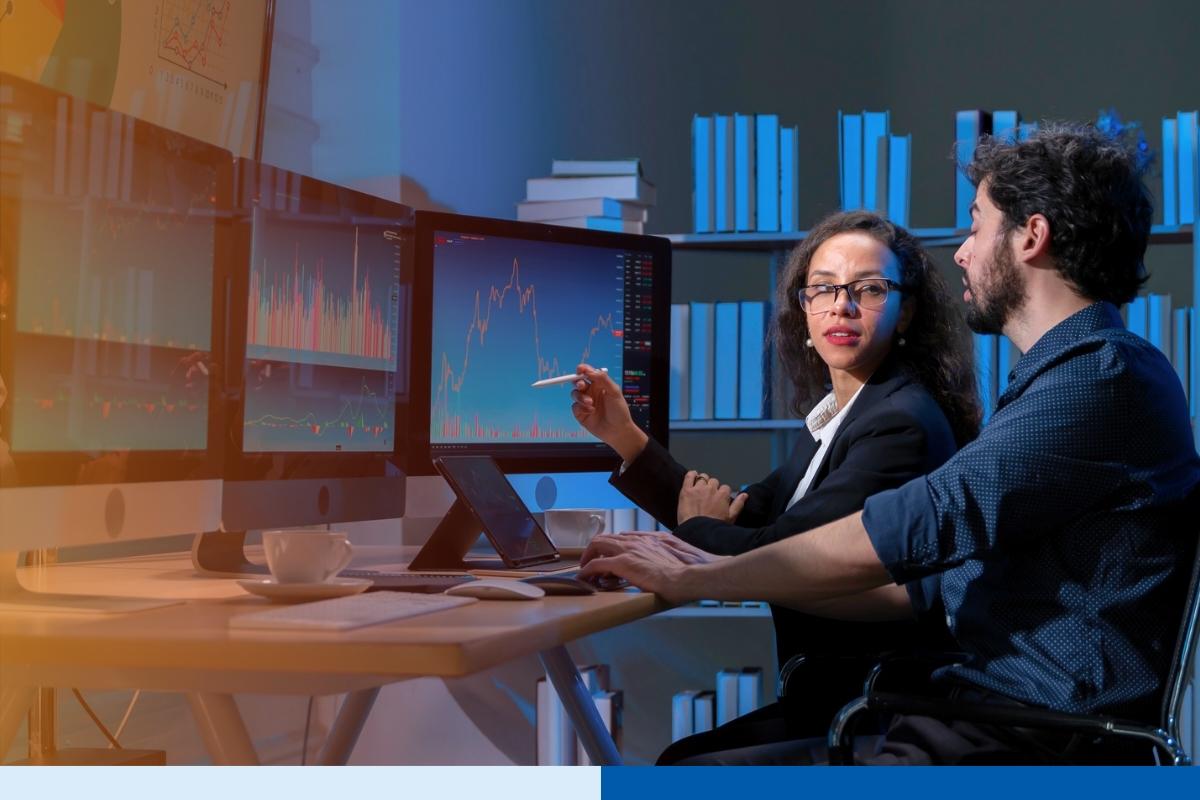 Remote Work Compliance in Remote Staffing two people with computer screens with data and bar graphs
