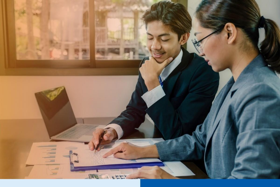 smiling people in corporate suit attire with paperwork and laptop in office