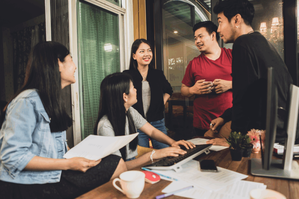 Team of professionals collaborating in a meeting, representing customer service outsourcing companies building dedicated offshore teams.