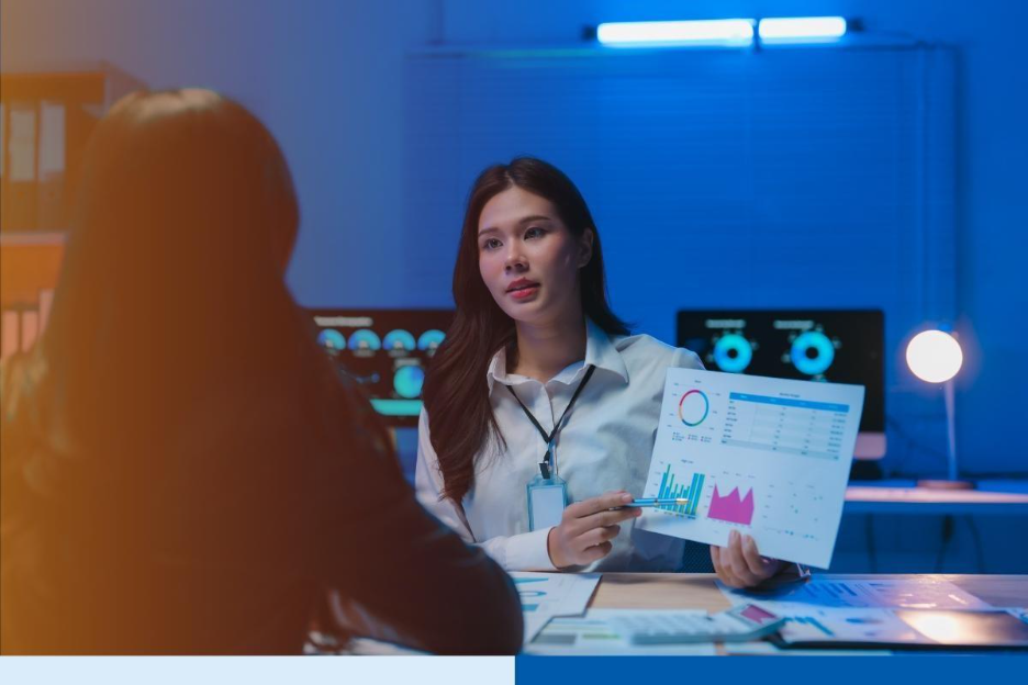 businesswoman showing charts to colleague in office