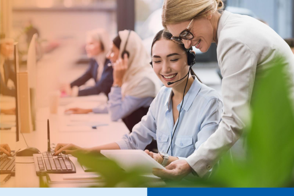 selective focus of smiling multicultural businesswomen using tablet together at workplace in office