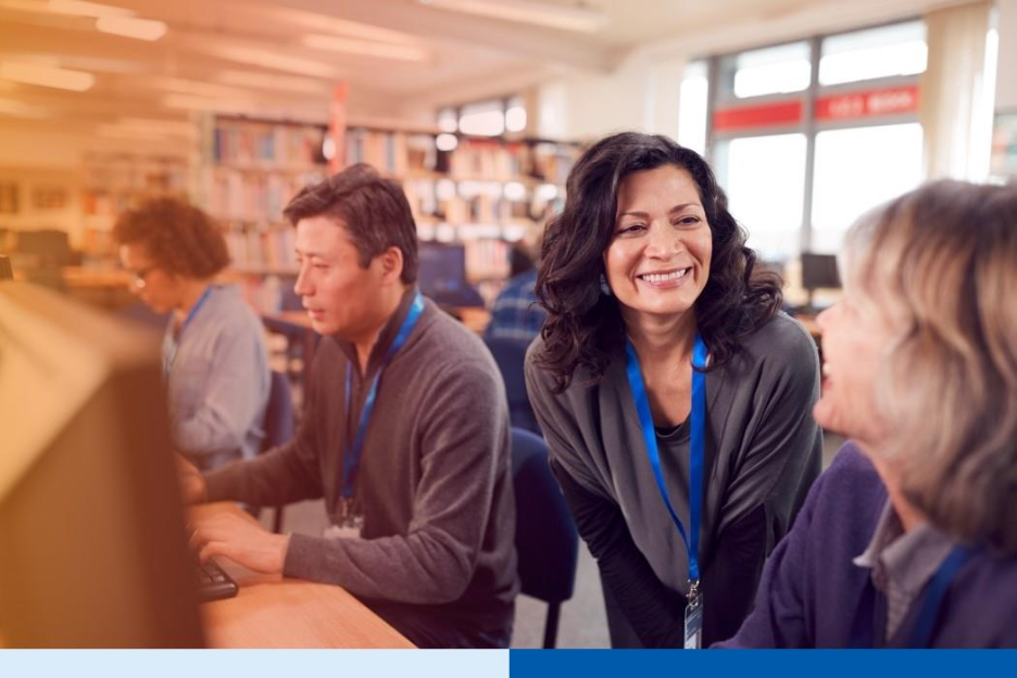 Business professionals working together in an office, illustrating employee rebadging and workforce flexibility during hiring freezes.