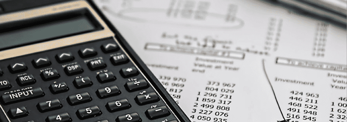 Financial paperwork, calculator, and accounting documents symbolizing offshore accounting operations
