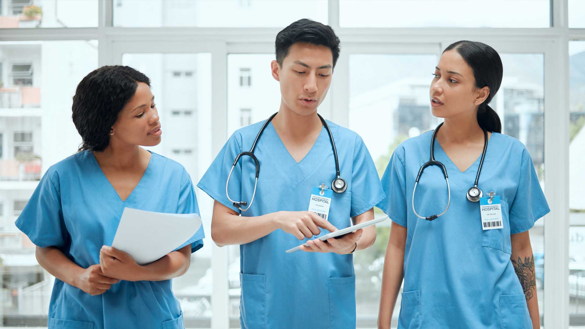 Medical Staff Discussing Data on Tablet in Hospital|An image of Warren Ratley, Vice President of Healthcare Services at Connext with his quote about co-management.