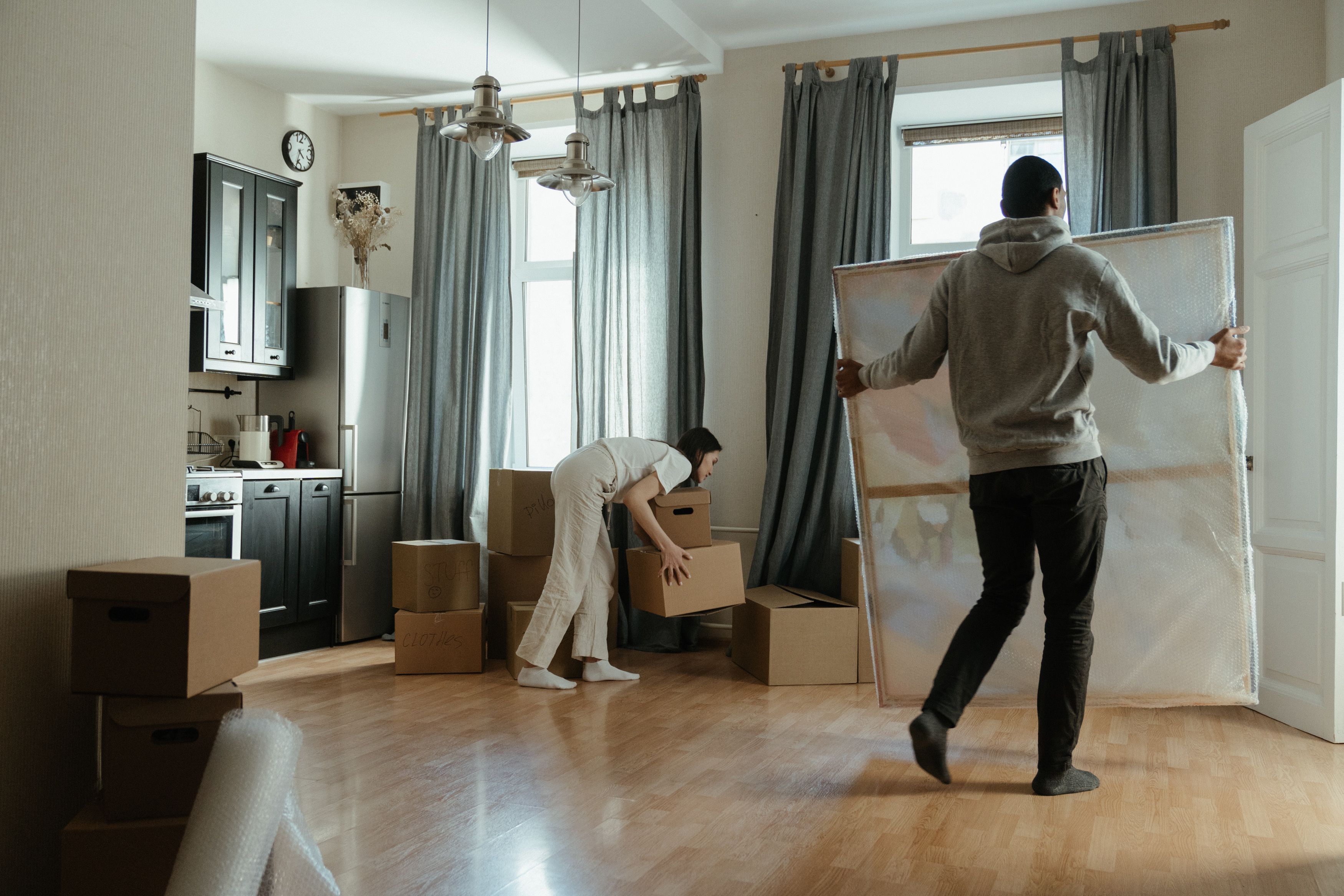 image of a humanitarian aid fundraising event, with volunteers stacking boxes in a modern yet welcoming space