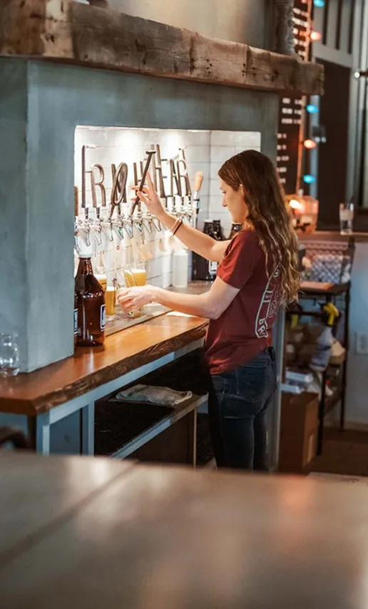 Bartender pouring a drink at a local Hartsville brewery