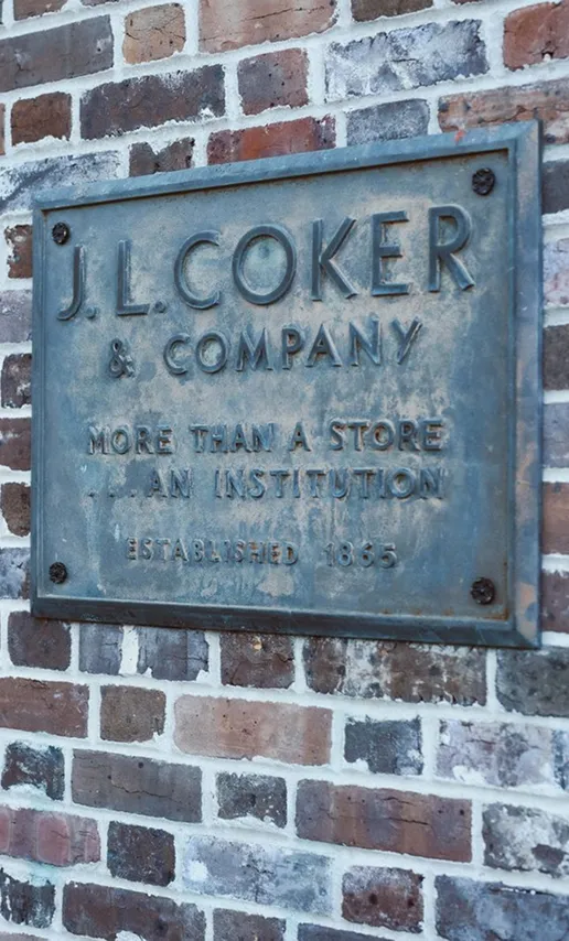 Historic J. L. Coker and Company plaque on a brick wall