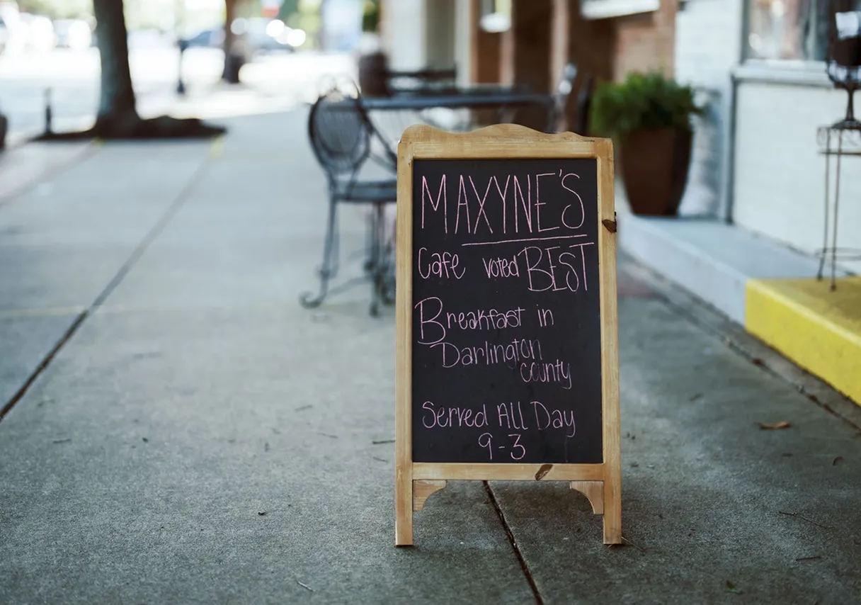 Maxyne’s Cafe breakfast sign on a downtown sidewalk