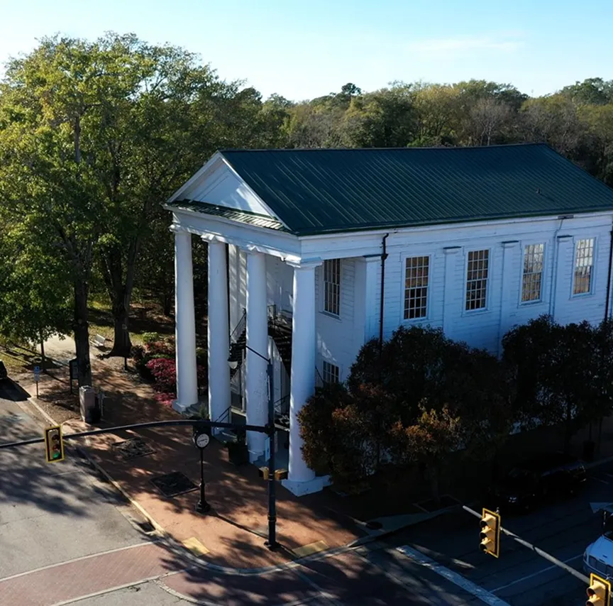 Historic white building with tall columns in downtown Cheraw