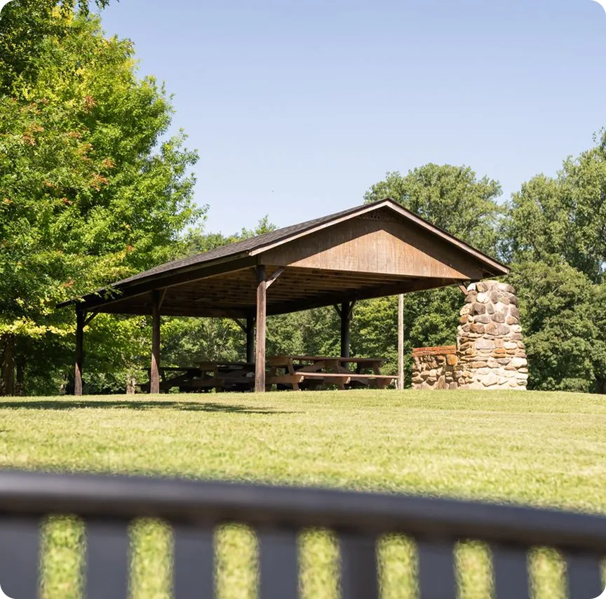Covered picnic pavilion with a stone fireplace in Cheraw