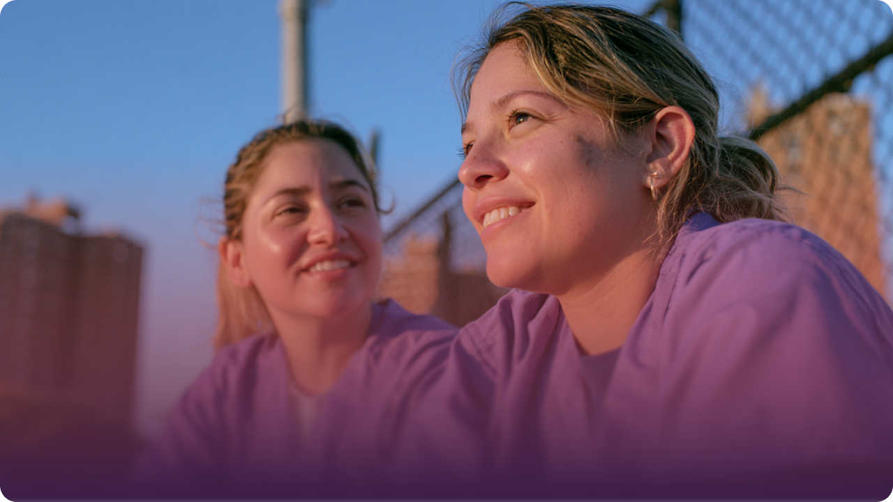 Two care team members smiling outdoors