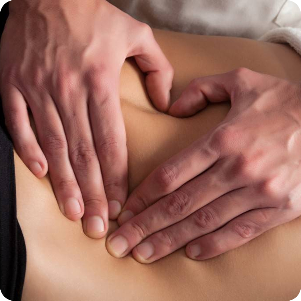Two hands pressing on a lower back performing a massage.